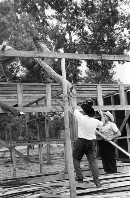 Construction of the gallows.  A miniature train will wind through the frontier city. Frank Fetter man, left, will be the engineer. All timber in the city was cut by hand