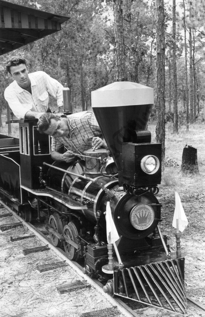 .A miniature train will wind through the frontier city. Frank Fetter man left, will be the engineer. All timber in the city was cut by hand.